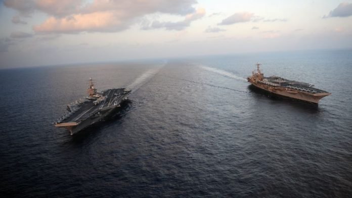 120123023012 hormuz ships 696x392