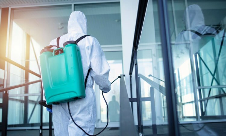 5f7b17cf man with tank reservoir his back spraying disinfectant stop corona virus 750x450